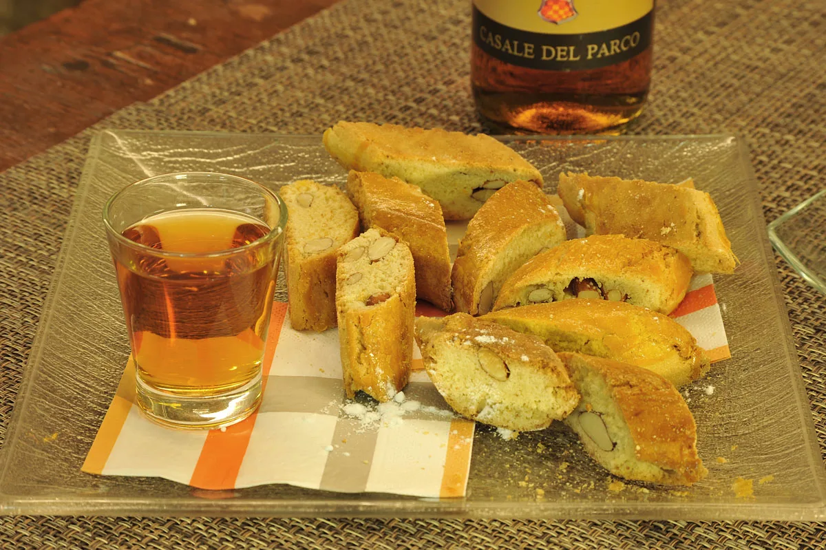 Cantucci alle mandorle e un bicchiere di vino dolce.